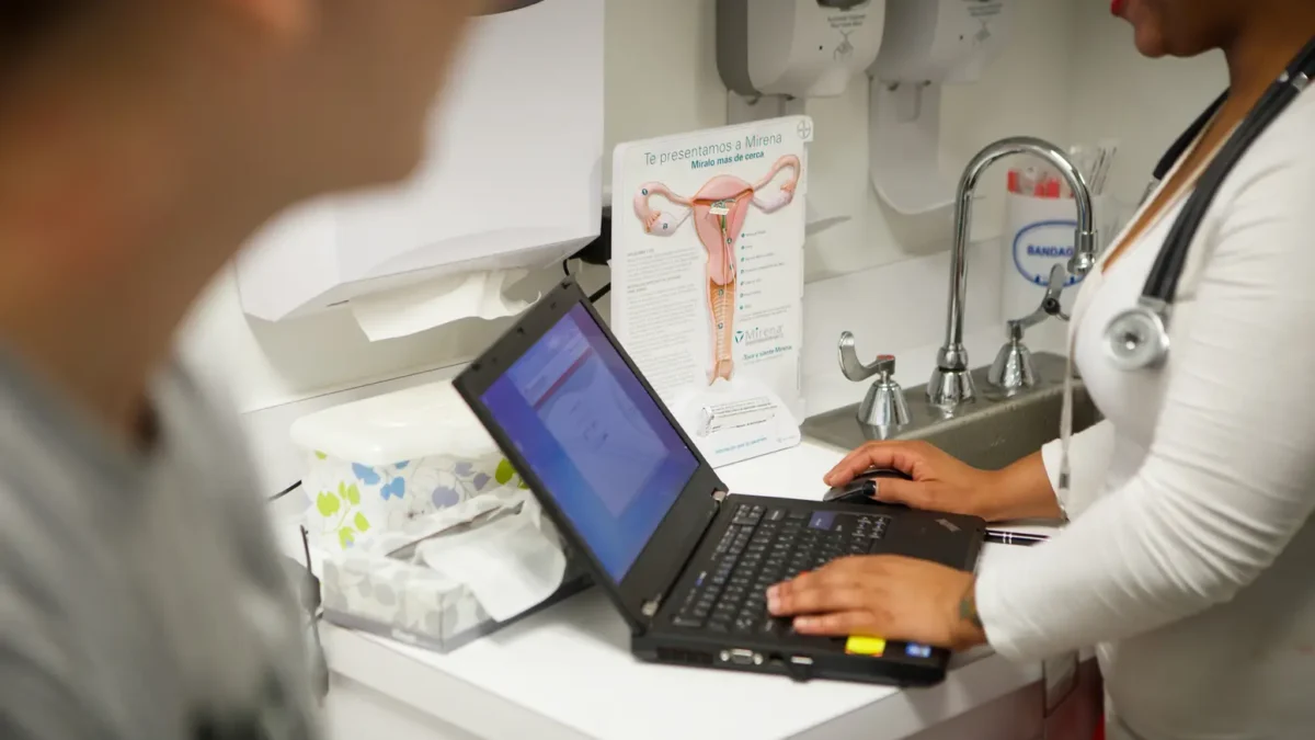 A nurse speaks with a patient at a clinic in Houston on Aug. 2, 2013. Credit: Michael Stravato for The Texas Tribune