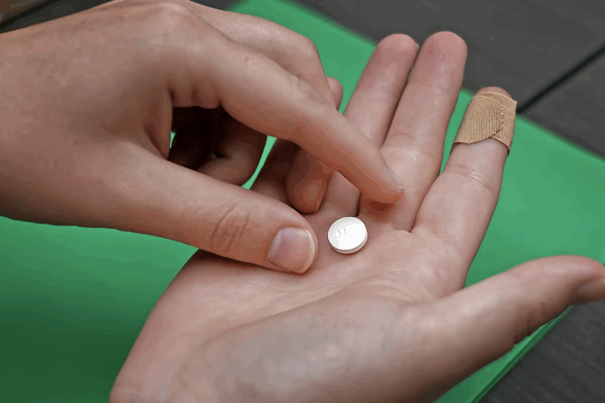 A patient prepares to take the first of two pills for a medication abortion during a visit to a clinic in Kansas City, Kan., on Oct. 12, 2022. (Charlie Riedel/AP)