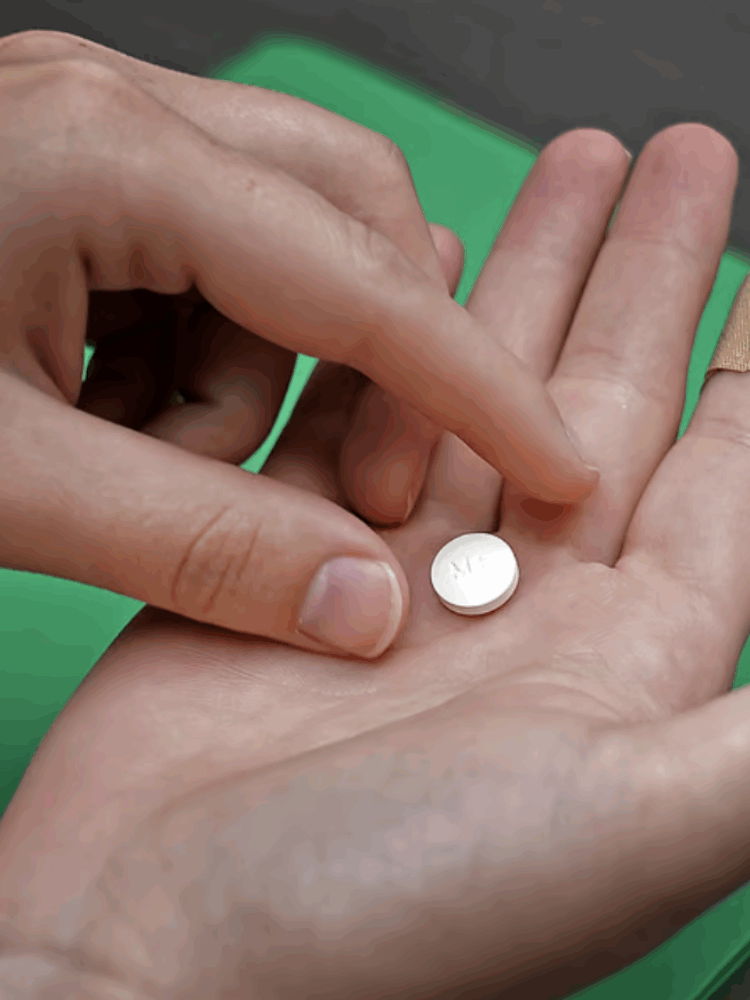 A patient prepares to take the first of two pills for a medication abortion during a visit to a clinic in Kansas City, Kan., on Oct. 12, 2022. (Charlie Riedel/AP)