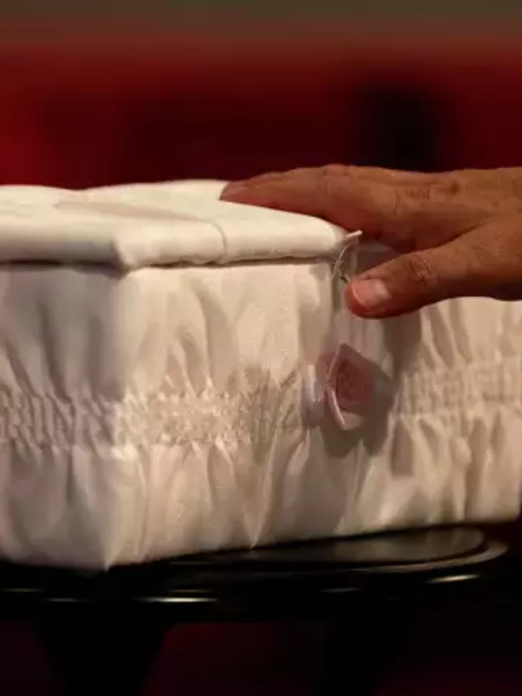 A man touches the casket of "Baby Mary" at a funeral service on San Antonio's Northwest Side. The mother had been accused of flushing the baby down a Whataburger toilet, causing injuries to her head. Authorities later determined that the woman had a miscarriage, not a live birth, and had not tried to flush the fetus down the toilet. Credit: Jessica Phelps