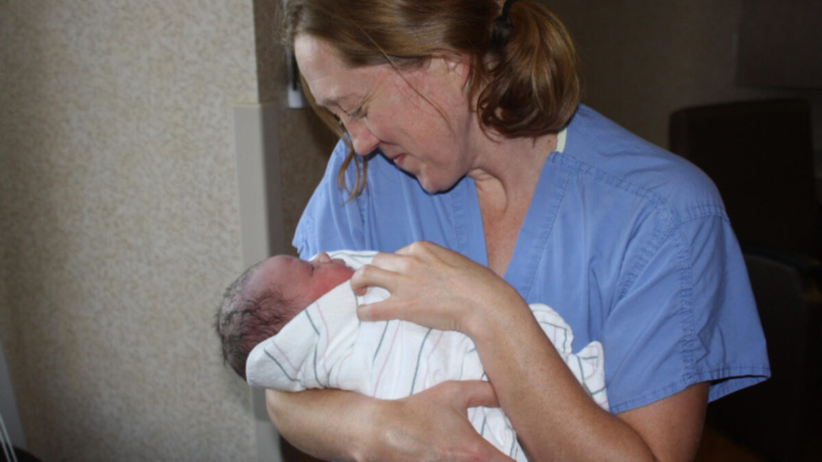 Dr. Becky Uranga, an OB-GYN in the Boise area of Idaho, holds one of many babies she has delivered over her 14 years of practice. As OB-GYNs and specialists have left Idaho after the implementation of a near-total abortion ban, Uranga said she is shouldering more work and feeling unable to give as much of her attention to some patients as she used to. (Courtesy of Dr. Becky Uranga)