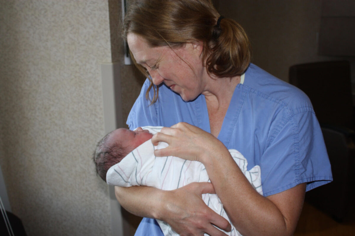 Dr. Becky Uranga, an OB-GYN in the Boise area of Idaho, holds one of many babies she has delivered over her 14 years of practice. As OB-GYNs and specialists have left Idaho after the implementation of a near-total abortion ban, Uranga said she is shouldering more work and feeling unable to give as much of her attention to some patients as she used to. (Courtesy of Dr. Becky Uranga)