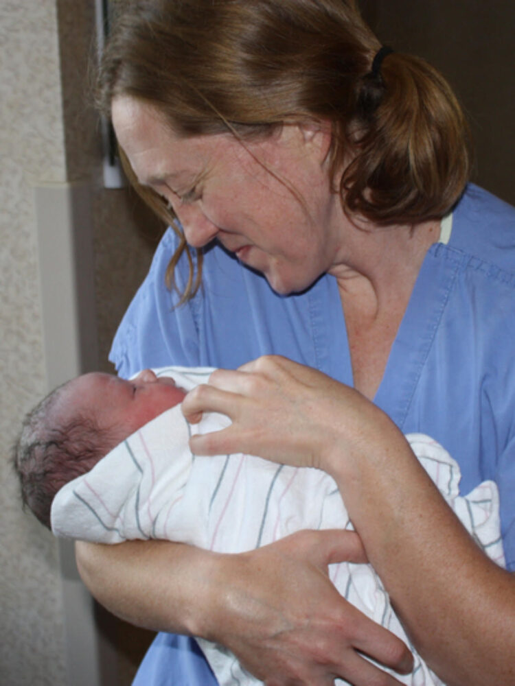 Dr. Becky Uranga, an OB-GYN in the Boise area of Idaho, holds one of many babies she has delivered over her 14 years of practice. As OB-GYNs and specialists have left Idaho after the implementation of a near-total abortion ban, Uranga said she is shouldering more work and feeling unable to give as much of her attention to some patients as she used to. (Courtesy of Dr. Becky Uranga)