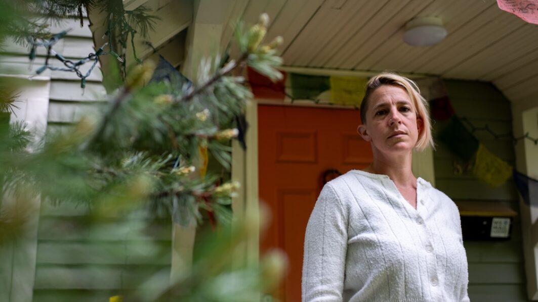 Rachel Castor, a single mom of two and teacher, stands outside her home in Sandpoint, Idaho. Castor’s son could not be admitted to the local hospital during an asthma attack because Bonner General Health lost its pediatrician coverage at the same time it closed the labor and delivery unit in 2023 following the Dobbs decision. (Photo by Erick Doxey for States Newsroom)