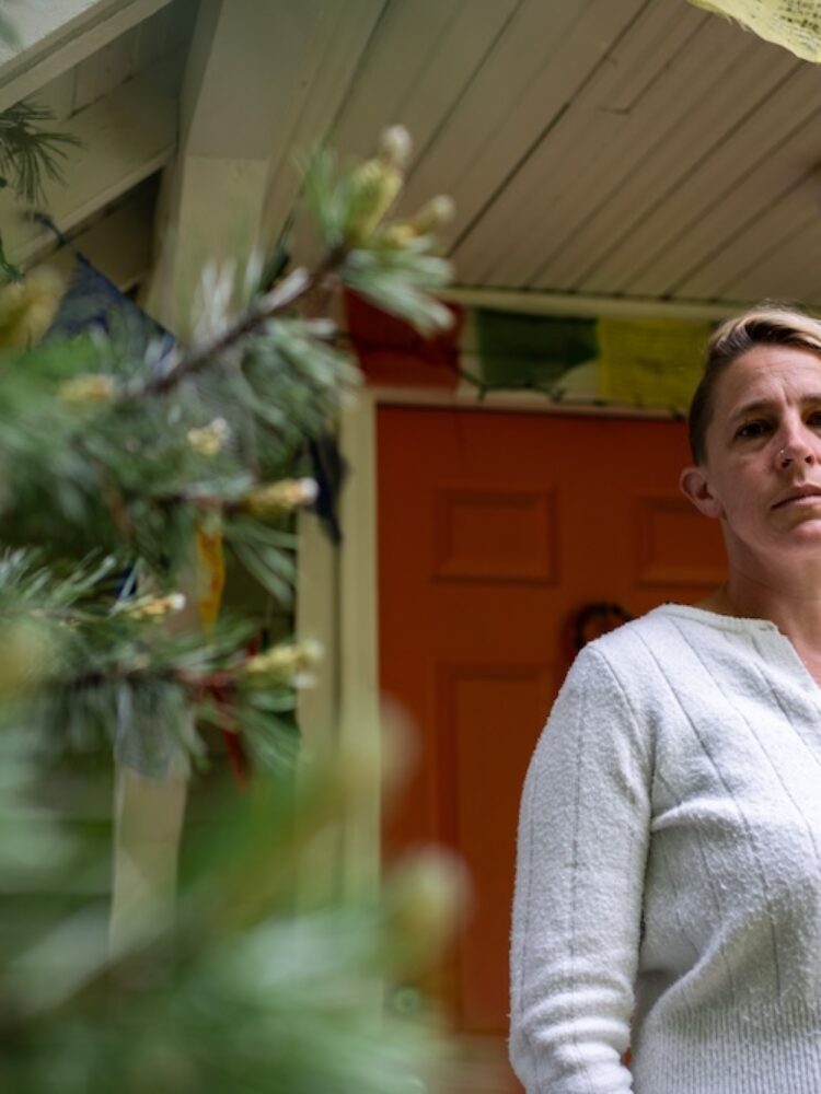Rachel Castor, a single mom of two and teacher, stands outside her home in Sandpoint, Idaho. Castor’s son could not be admitted to the local hospital during an asthma attack because Bonner General Health lost its pediatrician coverage at the same time it closed the labor and delivery unit in 2023 following the Dobbs decision. (Photo by Erick Doxey for States Newsroom)